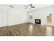 Bright living room featuring a fireplace, ceiling fan, and wood-look flooring at 51 Blackberry Ln, Benson, NC 27504