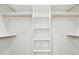 Spacious walk-in closet featuring built-in shelving and ample hanging space for optimal organization and storage at 51 Blackberry Ln, Benson, NC 27504