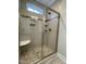 Modern bathroom featuring a glass enclosed walk-in shower with tiled walls, built-in shelves, and stone floor at 515 Sanctuary Trl, Cameron, NC 28326
