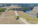 Aerial view of an empty land tract near the pond and road, surrounded by trees and green fields at 515 Sanctuary Trl, Cameron, NC 28326