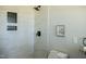 Shower area has white and gray marble-look tile with black fixtures and a black honeycomb tile niche at 5845 Farmwell Road Rd, Raleigh, NC 27610