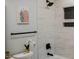 Modern bathroom features a shower with black fixtures and gray marble-look tile with black honeycomb tile niche at 5845 Farmwell Road Rd, Raleigh, NC 27610