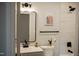 Stylish bathroom with modern vanity, updated fixtures and tiled shower at 5845 Farmwell Road Rd, Raleigh, NC 27610