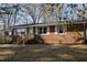 Charming brick home featuring a front porch and white shutters at 5845 Farmwell Road Rd, Raleigh, NC 27610