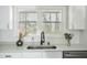 Bright and airy kitchen with white quartz countertops and stainless fixtures at 5845 Farmwell Road Rd, Raleigh, NC 27610