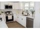 Well-lit kitchen with stainless appliances, white cabinets and subway tile backsplash at 5845 Farmwell Road Rd, Raleigh, NC 27610