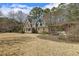Expansive backyard with lush lawn and a charming wooden pergola seating area at 6108 King Croydon Ct, Raleigh, NC 27603