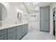 Modern bathroom featuring double sinks, a glass-enclosed shower, and custom cabinetry at 6108 King Croydon Ct, Raleigh, NC 27603