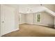 A spacious bedroom with natural light, ceiling fan, neutral tones, and comfortable carpeting at 6108 King Croydon Ct, Raleigh, NC 27603