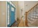 Bright entryway with a colorful front door and hardwood floors at 6108 King Croydon Ct, Raleigh, NC 27603