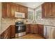 A gourmet kitchen boasts stainless steel appliances, tile backsplash, granite counters, and wood cabinets at 6108 King Croydon Ct, Raleigh, NC 27603
