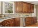 Updated kitchen showcases stainless steel appliances, wood cabinets, and granite countertops at 6108 King Croydon Ct, Raleigh, NC 27603