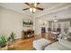 Open-concept living space boasts hardwood floors, a fireplace, and comfortable seating at 6108 King Croydon Ct, Raleigh, NC 27603