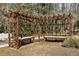 Detailed view of a wooden pergola with benches, creating a tranquil outdoor space at 6108 King Croydon Ct, Raleigh, NC 27603