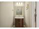 Cozy powder room with vanity, decorative mirror, and modern lighting at 6108 King Croydon Ct, Raleigh, NC 27603
