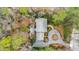 Aerial view of lush wooded lot, traditional style brick home, and circular driveway at 620 Marlowe Rd, Raleigh, NC 27609
