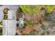 Brick home surrounded by mature trees with a landscaped yard and patio at 620 Marlowe Rd, Raleigh, NC 27609
