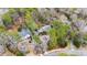 Aerial view of brick home in neighborhood with lush foliage, circle drive, and mature trees at 620 Marlowe Rd, Raleigh, NC 27609