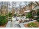 Brick home boasts a stone patio with outdoor seating overlooking the lush backyard at 620 Marlowe Rd, Raleigh, NC 27609