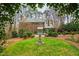 Expansive backyard with manicured lawn, water feature, and brick traditional home at 620 Marlowe Rd, Raleigh, NC 27609