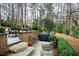 Bluestone patio with outdoor grill and dining, framed by beautiful landscaping at 620 Marlowe Rd, Raleigh, NC 27609