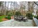 Outdoor dining set for six on a bluestone patio with a garden view at 620 Marlowe Rd, Raleigh, NC 27609