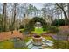 Relaxing backyard with a fire pit, seating, and view of the traditional style brick home at 620 Marlowe Rd, Raleigh, NC 27609