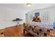 Bedroom offers wooden floors, a work desk, and a bed with a patchwork quilt at 620 Marlowe Rd, Raleigh, NC 27609