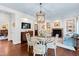 Inviting breakfast nook with a glass table, fireplace, built-in shelves, and blue couch at 620 Marlowe Rd, Raleigh, NC 27609