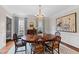 Formal dining room with hardwood floors, blue patterned rug, a wooden table and blue curtains at 620 Marlowe Rd, Raleigh, NC 27609