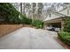 Long driveway leads to a garage with multiple parked cars and a basketball hoop at 620 Marlowe Rd, Raleigh, NC 27609
