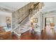 Traditional foyer with wallpaper, wooden floors and a beautiful staircase at 620 Marlowe Rd, Raleigh, NC 27609