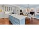 Open concept kitchen with a large island, and a breakfast nook with fireplace and a brick surround at 620 Marlowe Rd, Raleigh, NC 27609