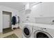 Bright laundry room includes front loading washer and dryer, plus hanging rack at 620 Marlowe Rd, Raleigh, NC 27609