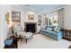 Comfortable living room featuring a brick fireplace, built-in shelves, and a plush blue sofa at 620 Marlowe Rd, Raleigh, NC 27609