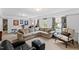 Cozy living room featuring plush seating, soft carpet, and bright natural light at 620 Marlowe Rd, Raleigh, NC 27609