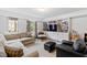 Cozy living room with a large window, neutral paint, built in shelves, and a sectional at 620 Marlowe Rd, Raleigh, NC 27609