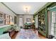 Well-lit office space with custom green built-ins, a patterned rug, and a large window view at 620 Marlowe Rd, Raleigh, NC 27609