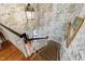 Elegant staircase with decorative wallpaper, carpeted steps, and a stylish lantern at 620 Marlowe Rd, Raleigh, NC 27609