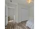 Bright bedroom with white walls, hardwood floors, and a closet for storage at 6306 Winding Arch Dr, Durham, NC 27713