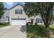 Charming two-story home with a well-manicured lawn and a classic garage at 6306 Winding Arch Dr, Durham, NC 27713