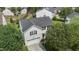 Aerial view of a two-story house with black shutters, surrounded by mature trees at 6306 Winding Arch Dr, Durham, NC 27713