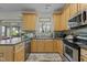 Cozy kitchen featuring stainless steel appliances, wooden cabinets, and lots of counter space at 6306 Winding Arch Dr, Durham, NC 27713