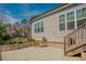 Inviting backyard patio with a table and chairs, a screened-in porch, and lush green landscaping at 65 Walking Trl, Youngsville, NC 27596