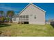 Backyard view of home featuring a patio, screened-in porch, and green lawn at 65 Walking Trl, Youngsville, NC 27596