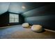 Dark bonus room features two large beanbag chairs, carpeted floors, and a window for natural light at 65 Walking Trl, Youngsville, NC 27596