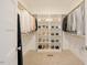 Walk-in closet with built-in shelves and clothing racks at 65 Walking Trl, Youngsville, NC 27596