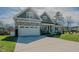 Inviting home with a well-manicured lawn and a spacious driveway for parking at 65 Walking Trl, Youngsville, NC 27596