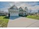 Attractive home featuring an extra long driveway and a stone-accented attached garage at 65 Walking Trl, Youngsville, NC 27596