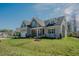 Inviting home with an attached garage, well-kept lawn, and easy access to outdoor activities at 65 Walking Trl, Youngsville, NC 27596